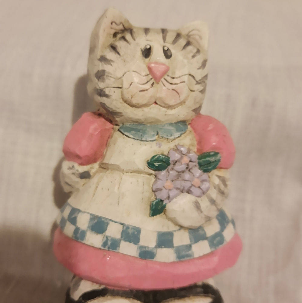 Midwest  cat wearing pink dress holding flowers
